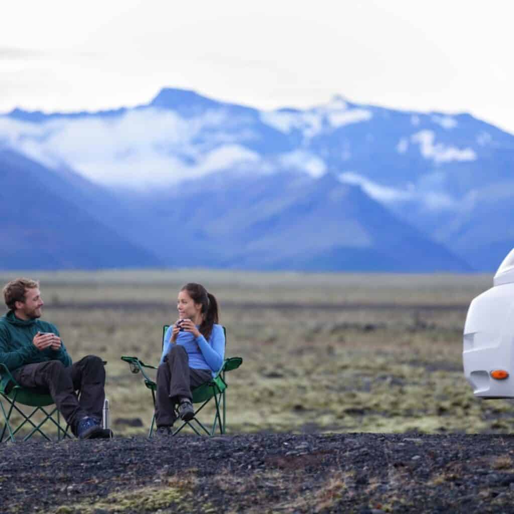 image of couple sitting outside drinking coffee for post 10 reviews your guide for buying the best coffee maker for rv