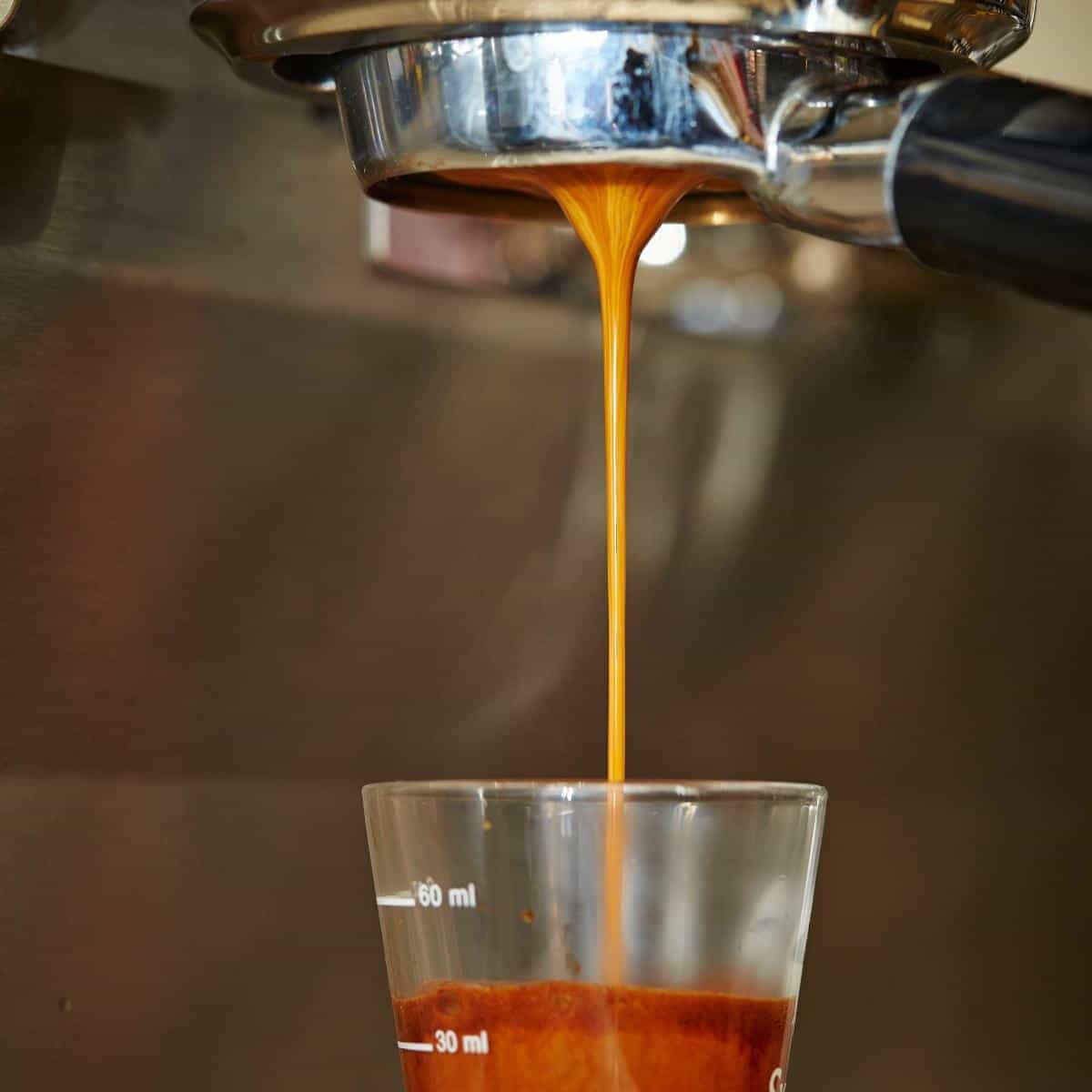 image of coffee being poured into glass for the post 5 of the best bean to cup coffee machines that will meet your needs